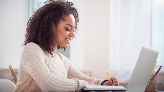 Smiling Student Studying Laptop