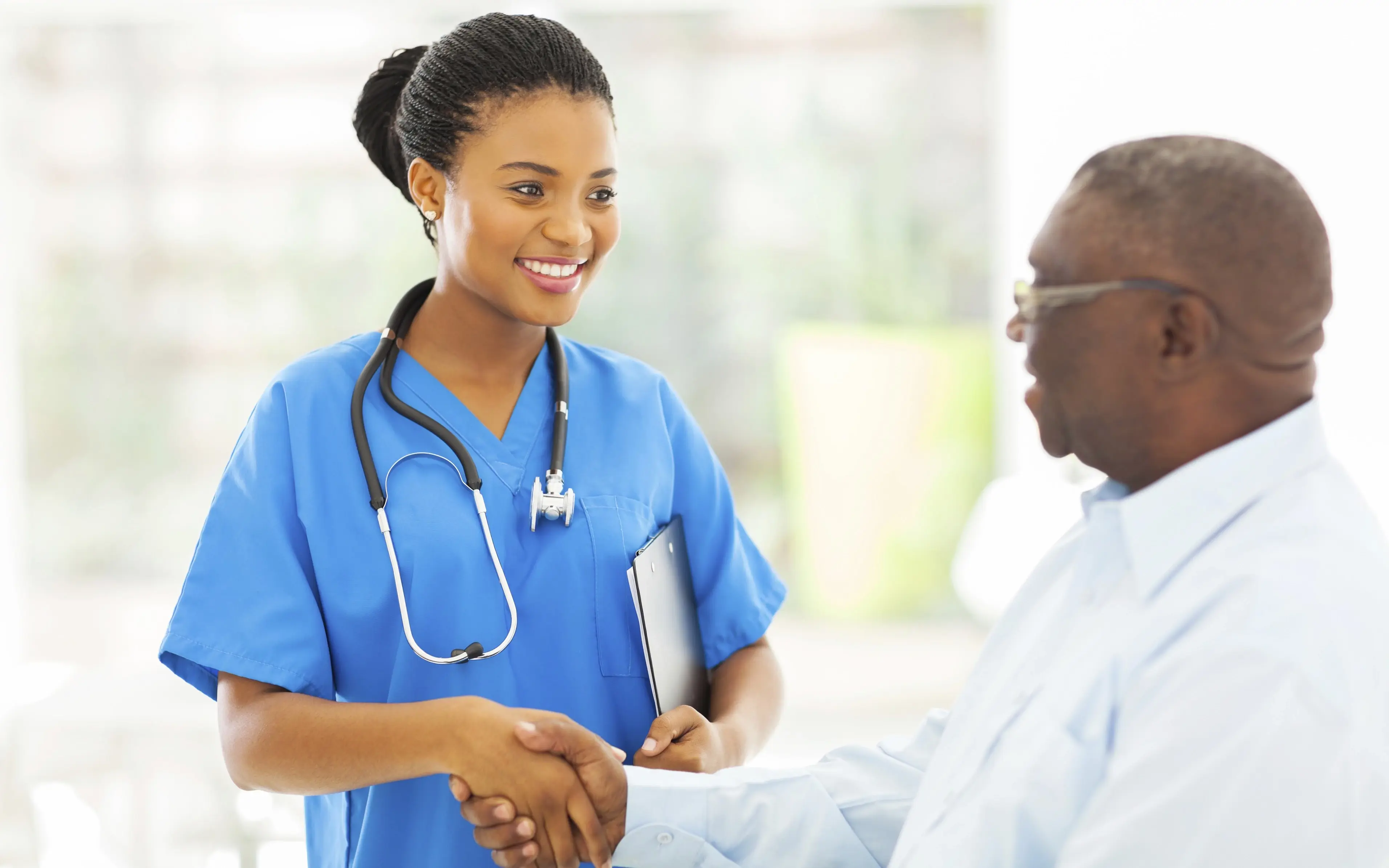 Black woman doctor interviewing patient